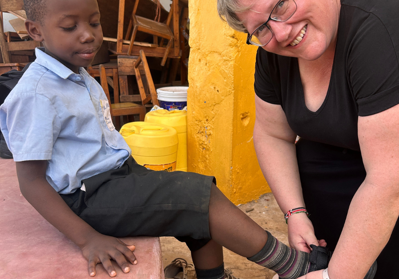 Tanya from SoleLution fitting shoes on children at Jolaurabi school in Kenya, run by the charity Educate the Kids.