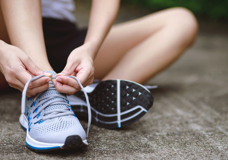 a person tying their shoe laces