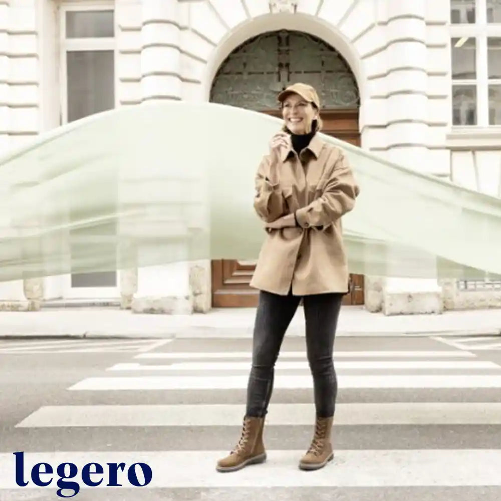 Person wearing a beige coat standing on a zebra crossing with 'legero' branding.